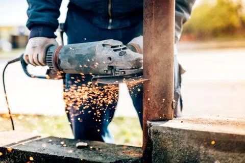 Details of worker using electric angle grinder mitre saw for cutting metal  Stock Photos