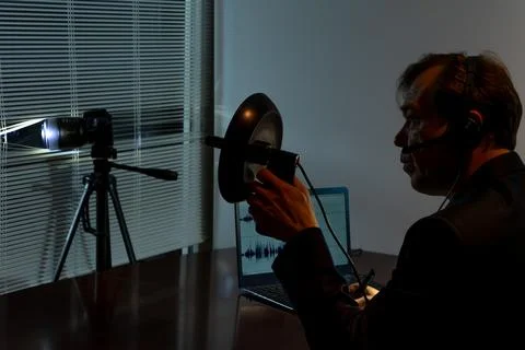The detective conducts covert surveillance using modern gadgets and sound r.. 스톡 사진