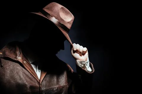 Detective face profile putting on hat. Stock Photos