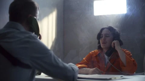 Detective Presenting Photo and Interrogating Inmate during Prison Visit Stock Footage 311201723