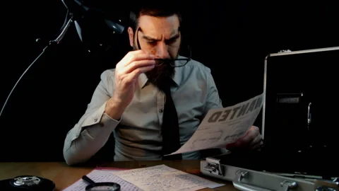 Detective sitting while examining documents of the Zodiac serial killer case Stock Footage 150942074