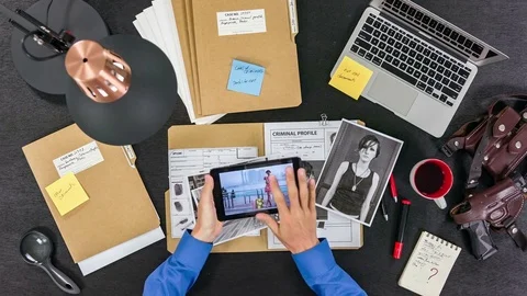 The detective is studying the documents of the agent under cover. Top view Stock Footage 80214935