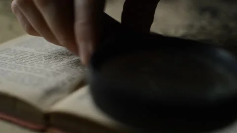 Detective using a magnifying glass  for detection investigation. Video stock 224095321