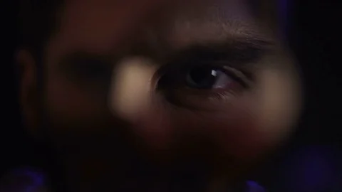 Detective watching camera roll through magnifying glass, searching gang bonds Stock Footage 85057614