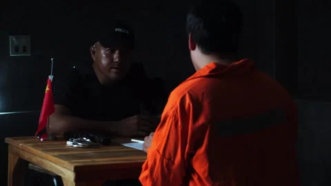 Detectives and prisoner in dark interrogation room Stock Footage 276832128