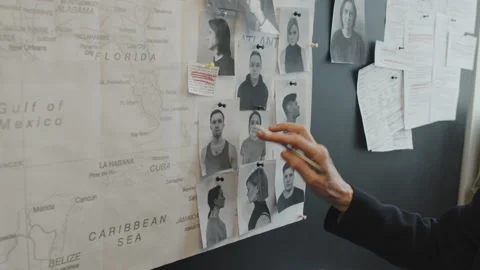 Detectives Looking at Photos of Suspects Stock Footage 199279490