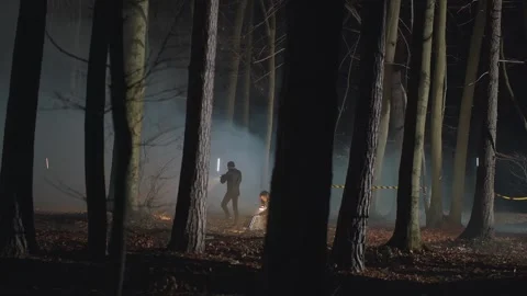 Detectives or criminologists with flashlights working on restricted crime scene Stock Footage 246869225