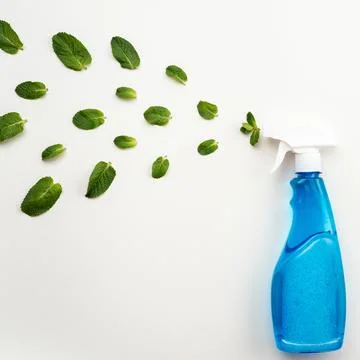 Detergent blue bottle with white cap on a white background spray a fresh mi.. Stock Photos