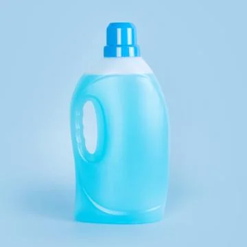 Detergent bottle on blue background. Plastic container of cleaning product, h Stock Photos