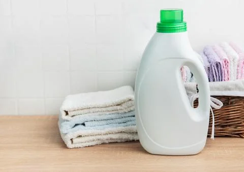 Detergent bottle, laundry and clean fresh towels Stock Photos