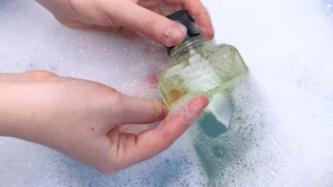Detergent bottles float in the foam. The concept of the dangers of household che Stock-Footage 146720348
