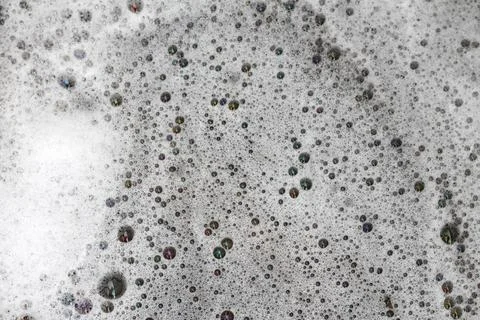 Detergent bubbles float in the waste water. Stock Photos