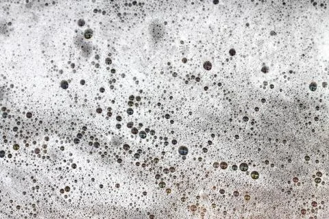 Detergent bubbles float in the waste water. Stock Photos