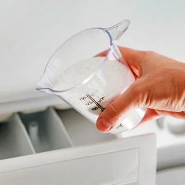 Detergent in dosing cup for laundromat Stock Photos