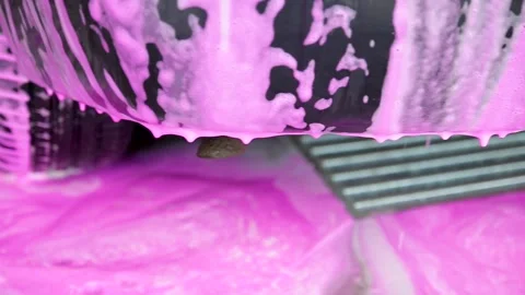 Detergent, red foam, shampoo drains from the car. Stock Footage 157476475