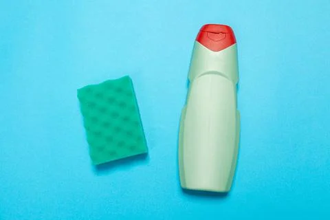 Detergent for various surfaces and rag sponge Light pastel blue background. P Stock Photos