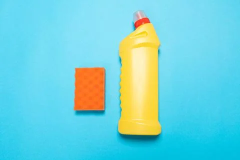Detergent for various surfaces and rag sponge Light pastel blue background. P Stock Photos