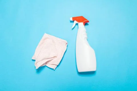 Detergent for various surfaces and rag sponge Light pastel blue background. P Stock Photos