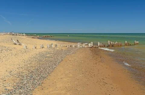 Deteriorating Dock Posts on a Lonely Shore Photos