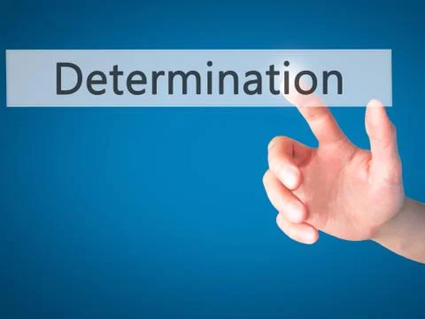 Determination - Hand pressing a button on blurred background concept on visua Foto stock