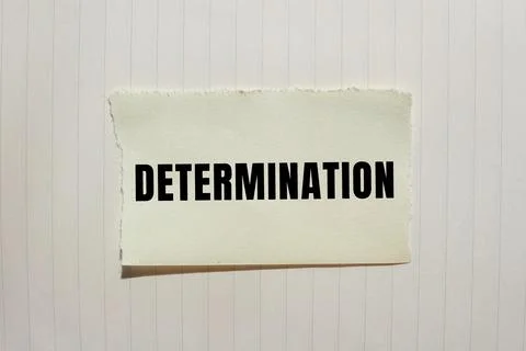 Determination message written on ripped torn paper background. Conceptual D.. Foto stock