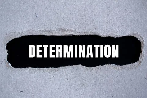 Determination message written on ripped torn paper background. Conceptual D.. Stock Photos