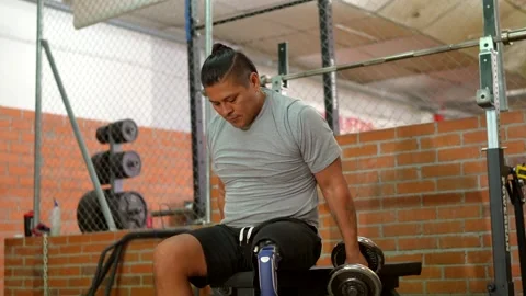 Determined amputee athlete training with prosthetic leg in gym Stock Footage 317759707