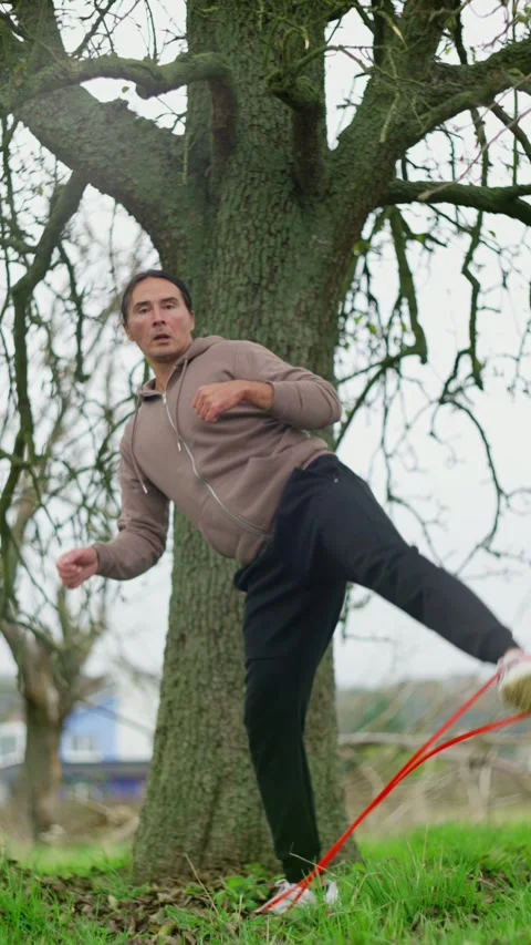 Determined and focused athlete is performing a stretching exercise outdoors Video stock 302655089