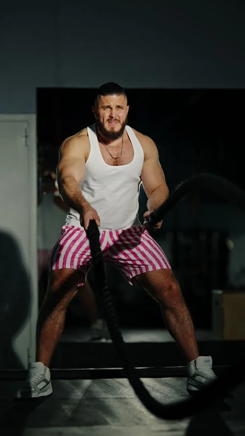 Determined athlete powering through an intense battle rope session in a gym Stock-Footage 329558082