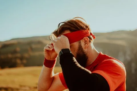 A determined athlete preparing for the start of training on the top of the Stock Photos