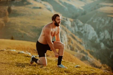 A determined athlete preparing for the start of training on the top of the Stock Photos