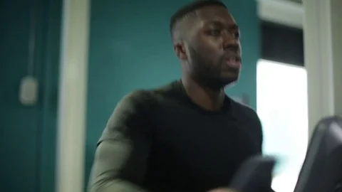 Determined Athlete Trains on Elliptical Machine at Gym Stock Footage 72551653