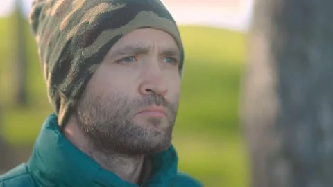 A Determined bearded Man in a Beanie, Captured in an Introspective Moment Stock Footage 288673209