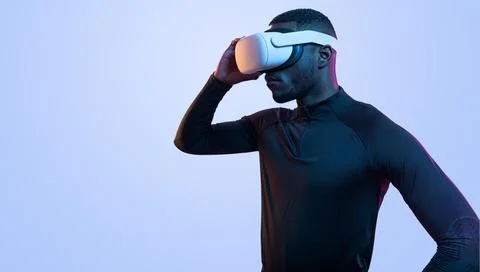 Determined black man in VR headset Stock Photos