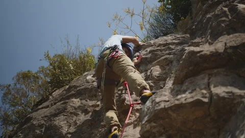 Determined Climber Ascending a Steep Cliff with Expertise and Agility. Stock Footage 272818582