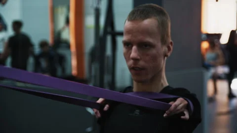 Determined disabled athlete training with resistance band Stockbeeldmateriaal 322015330