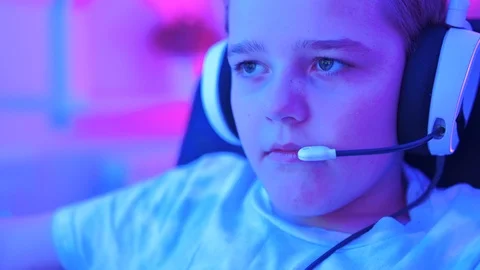 Determined esports player looks at computer screen while playing video game Stock Footage 122524408