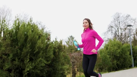 A determined female runner jogging in the park. Stock Footage 234136954