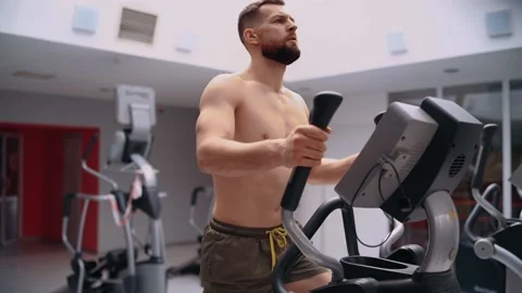 The determined man, with a bare chest, does in slow motion the training on the Stock Footage 156481268