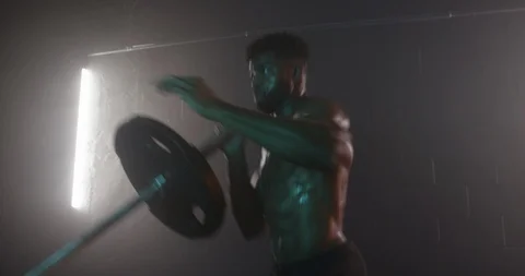 Determined man doing workout exercise with barbell in gym Stock Footage 116360310