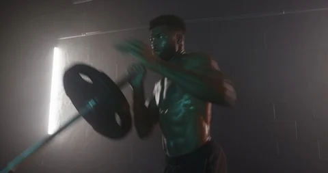 Determined man doing workout exercise with barbell in gym Stock Footage 116360429