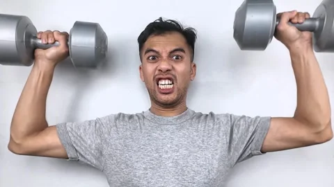 Determined Man Gritting Teeth Lifting Heavy Dumbbells During Intense Workout. Stock Footage 315443474