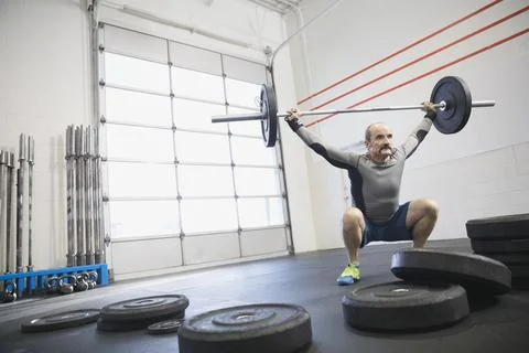 Determined man practicing Olympic lifts Stock Photos