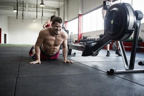 Determined Man Practicing Pushups In Gym 写真素材