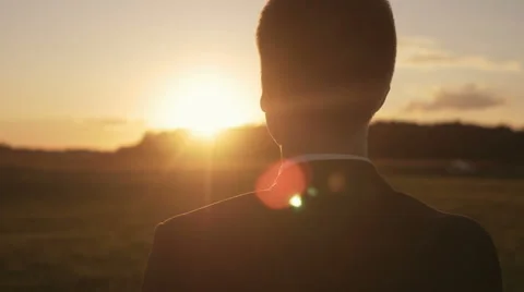 Determined man thinking about the future as he looks at the sun Stock Footage
