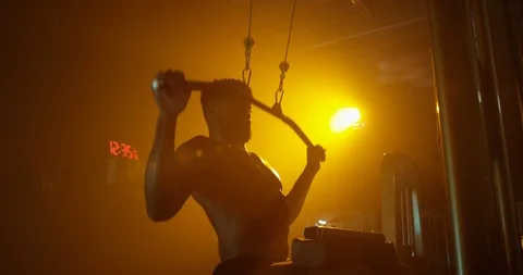 Determined man working out with exercise equipment in the gym Stock Footage 116359165