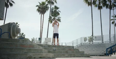 Determined man working out on steps on a sunny day in slow motion Stock Footage 106192990