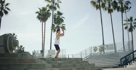 Determined man working out on steps on a sunny day in slow motion Stock Footage 106193545