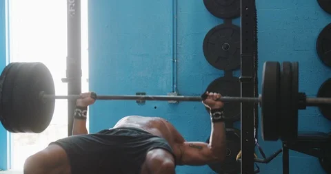 Determined mature man doing bench press exercise for chest Stock Footage 116390634