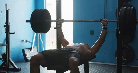 Determined mature man doing chest exercise on the bench press Stock Footage 116392457